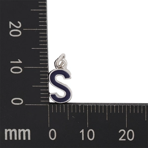 Detailed macro view of navy blue enamel letter S pendant charm with silver metal border