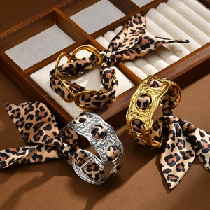 Three-piece set of leopard print silk scarves wrapped on gold and silver cuff bracelets