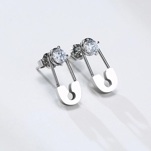 Detailed view of silver safety pin earrings with round cubic zirconia and S925 butterfly back