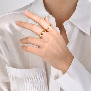 Minimalist gold stainless steel ring set shown on hand with high polish mirror finish