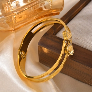 Detail of gold double-layer bangle with Forever Love hearts and pave diamond accents