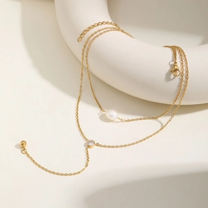Detailed macro view of the double-layer gold Y-necklace with zircon and pearl accents