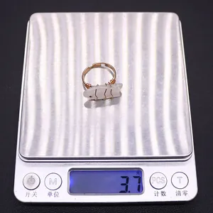 Detail shot of handmade fish-shaped white stone ring on a scale weighing 3.7 grams