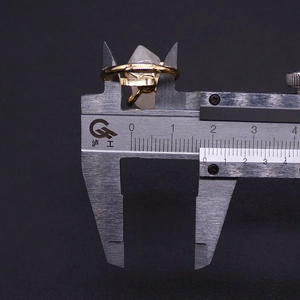 Detail view measuring natural pink crystal stone on a golden ring with a caliper
