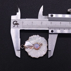Detailed measurement of peach blossom pendant with shell and opal using a digital caliper