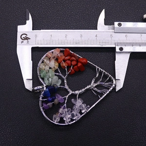 Detail view of handmade 7 chakras heart tree pendant measuring approximately 5.6cm wide