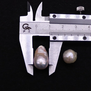 Detail view of irregular baroque pearls measured with a caliper showing size and high luster
