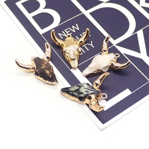 Bohemian acrylic bull head pendants set in gold, white, and tortoiseshell styles