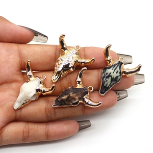Set of four acrylic bull skull charms with gold plating for DIY bohemian jewelry making
