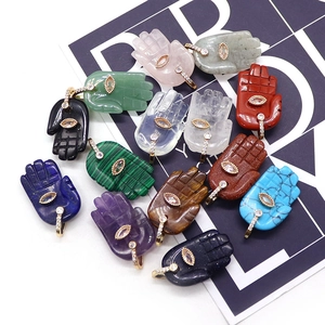 Hamsa hand pendants made of natural stones like lapis lazuli and amethyst with zircon eye