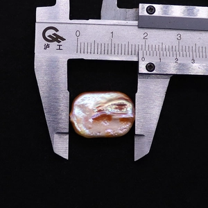 Macro detail of a 18mm pink baroque freshwater pearl measured with a caliper