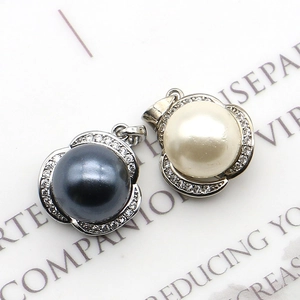 Silver flower pearl pendant with pavé crystals in black and white styles on a page