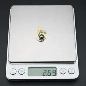 Detailed view of luxury black shell pearl pendant with zircons weighing 2.69g