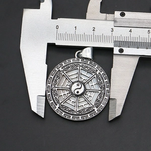 Macro shot of 34mm Tai Chi Bagua pendant diameter measurement with metal caliper