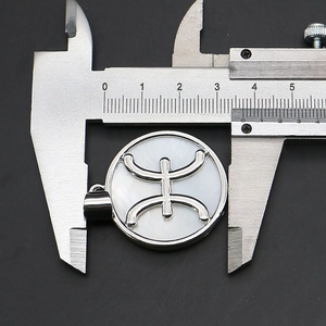 Macro shot of a 35mm natural shell pendant showing the diameter with a caliper