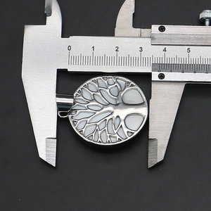 Measuring the 3.5cm tree of life round shell pendant with a digital caliper tool
