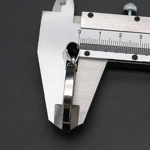Macro shot measuring 4.5mm thickness of the circular shell pendant with a digital caliper