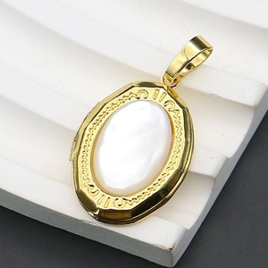 Detail view of oval gold locket pendant with iridescent white mother of pearl inlay
