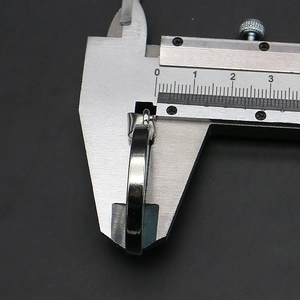 Caliper measuring the 5mm thickness of a silver sunflower shell pendant base