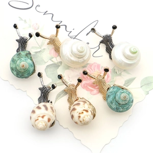 Elegant snail shell brooches with crystal and shell accents in gold and silver plating