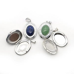 Vintage oval locket pendant with natural stones and intricate floral engraving details