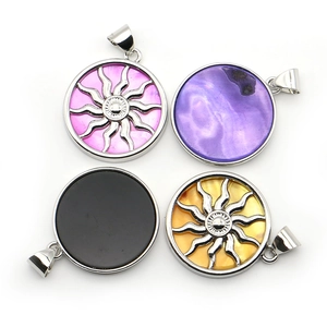 Set of four round shell pendants with electroplated sun totems for DIY jewelry making