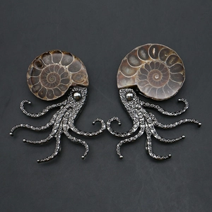 Macro detail of octopus ammonite pendant with fossil texture and antique silver tentacles