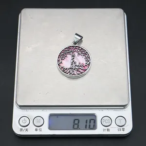 Detail showing family tree shell pendant on a scale weighing approximately 8.10g