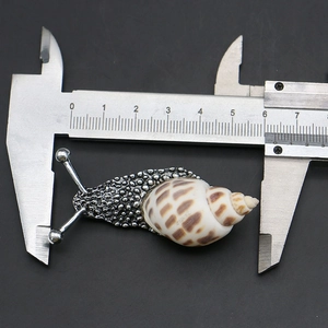 Measuring creative shell snail pendant with calipers showing the 60mm length detail