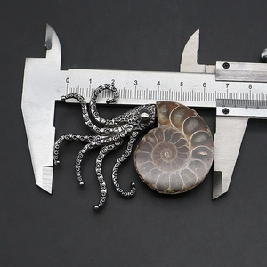 Macro shot showing 6.5cm width of silver octopus ammonite fossil pendant with caliper
