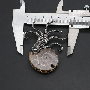Detailed close-up of ammonite fossil pendant with silver octopus head measuring 50mm