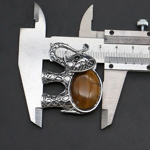 Macro shot showing dimensions of an elephant tiger eye stone pendant using a caliper
