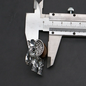 Detailed view of tiger eye stone elephant pendant with measurement using a caliper
