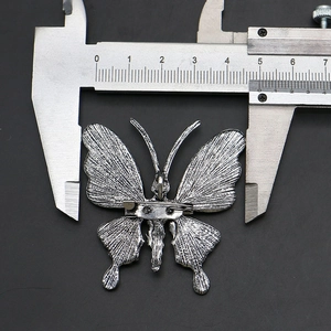 Macro detail of butterfly brooch back with pin and measurement showing 4.6cm width