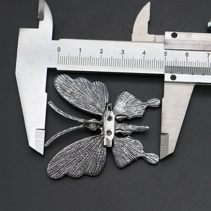 Silver butterfly brooch measurement showing width of 4.8cm on a dark background