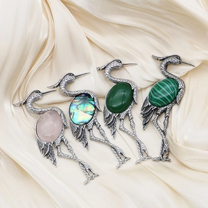Vintage crane-shaped natural stone brooches in rose quartz and green agate finishes