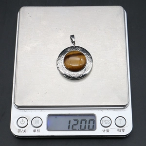 Tiger eye stone locket pendant weighed at 12.00g on a digital scale for necklace making