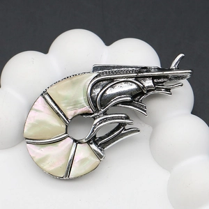 Macro shot of zinc alloy lobster brooch with iridescent mother of pearl shell inlay