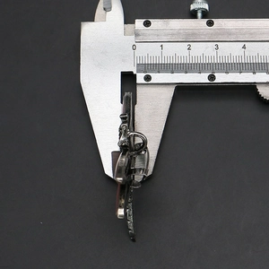 Macro view measuring the thickness of shell dragonfly pendant with a digital caliper