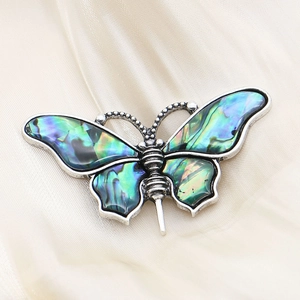 Zinc alloy butterfly pendant brooch with iridescent abalone shell inlay on silk fabric