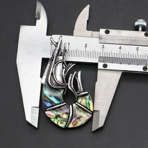 Detail view of the abalone shell shrimp pendant with caliper measuring 35mm width