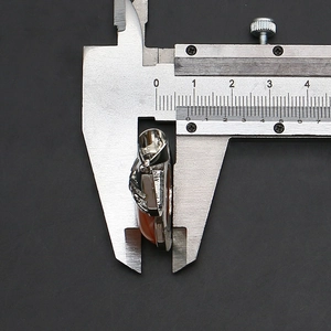 Thickness measurement of red gemstone gourd pendant showing 8-9mm depth on caliper