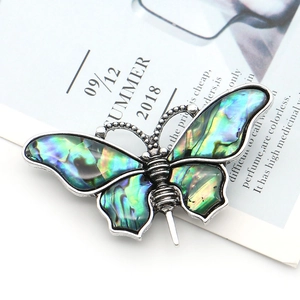 Silver zinc alloy butterfly brooch with iridescent abalone shell wing inlay detail