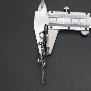Detail view of flower shell brooch thickness measured with a digital caliper tool