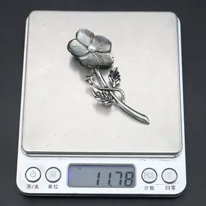 Weight measurement showing this flower brooch is approximately 11.78 grams