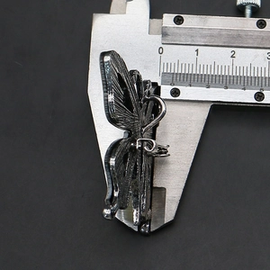 Macro view of butterfly pendant thickness measured by a digital caliper tool