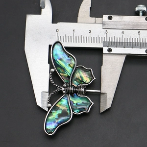 Measuring tool showing the 31mm width of the silver butterfly brooch with abalone shell inlay