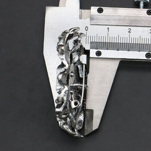 Macro view measuring the 6mm thickness of the silver antique style crab brooch