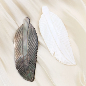 Natural mop shell feather pendants in white and black with iris sheen and fine carvings