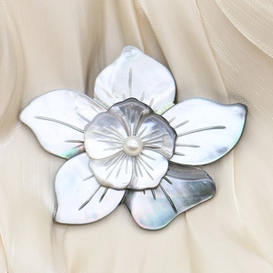 Elegant shell flower brooch with natural mother of pearl petals and a pearl center